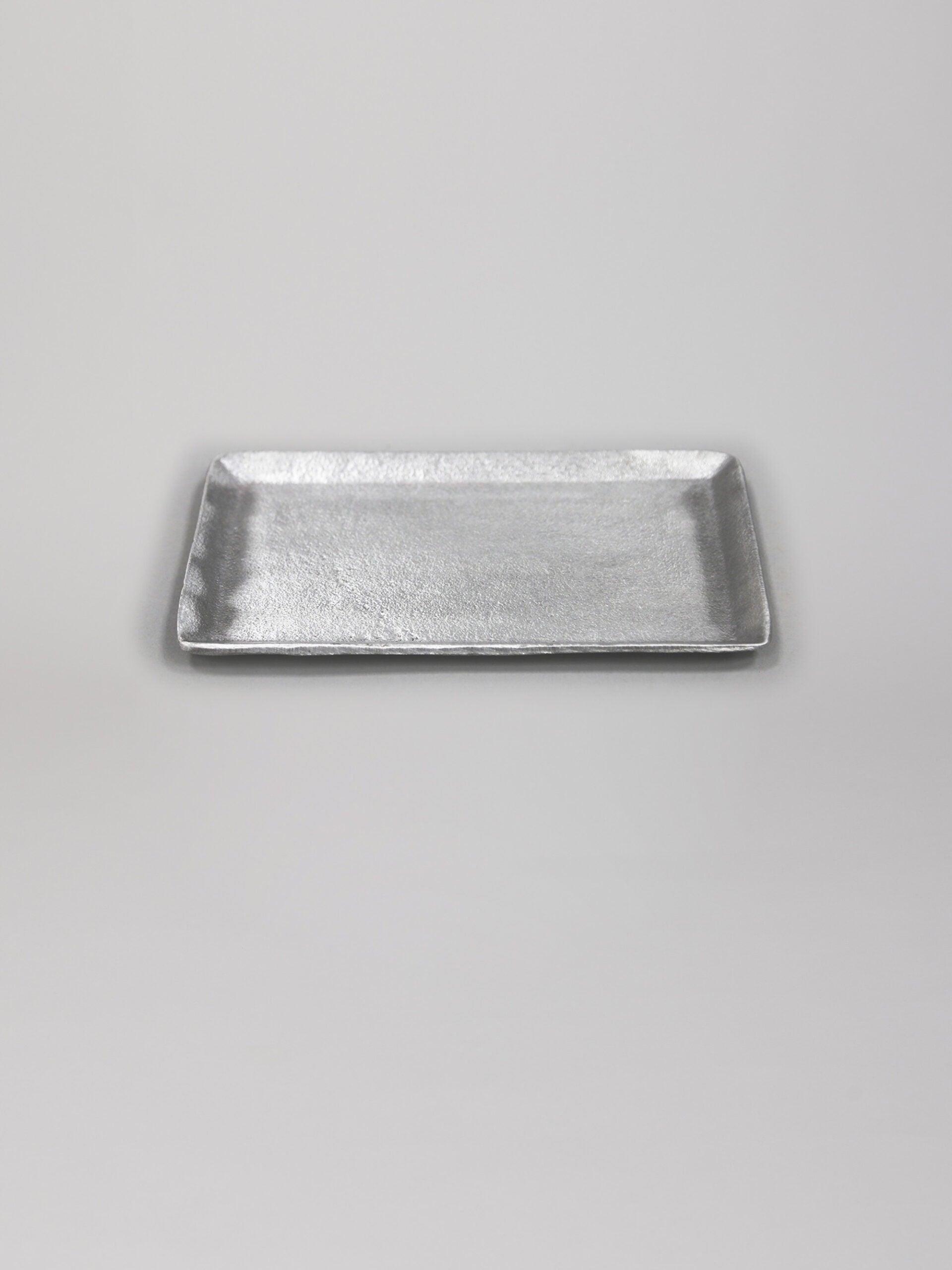 מגש כסף קטן על רקע אפור בהיר